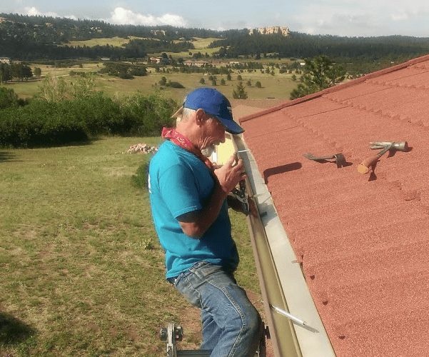 Best Buy Gutter team member repairing a gutter system