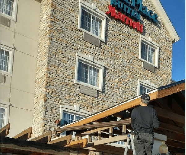 Best Buy Gutter team members installing a gutter system at the TownePlace Suites by Marriott